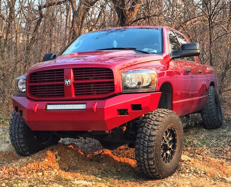 Red 3rd gen Ram 2500 on a Dodge Off Road 3-inch suspension kit, parked on a dirt hill